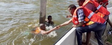 Two persons being rescued from drowning