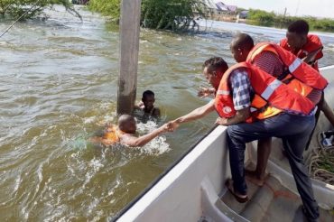 Two persons being rescued from drowning