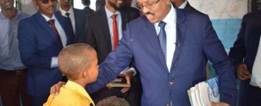 President Farmajo of Somalia providing books to school